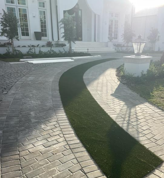 Curved front walkway with pavers and turf inlay